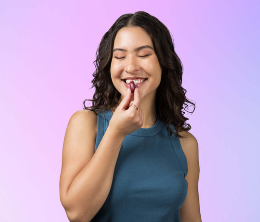 Woman putting Sambucus Ultra Immune Juicy Burst Chew into her mouth