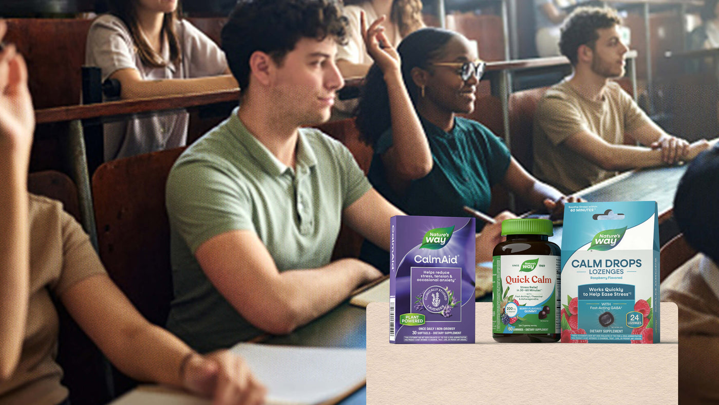 Students seated in a classroom with wellness products displayed in the foreground: a purple Calm Aid box, a green bottle of Quick Calm drops, and a blue box of Calm Drops.