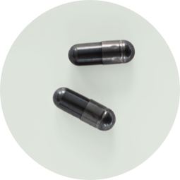 Two charcoal capsules.