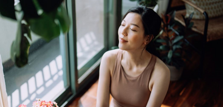 woman looking content with eyes closed after yoga and meditation