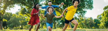 A family running through an open field