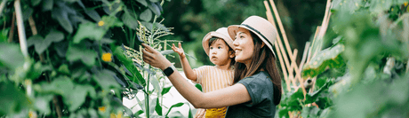 Young mom and child admiring a garden