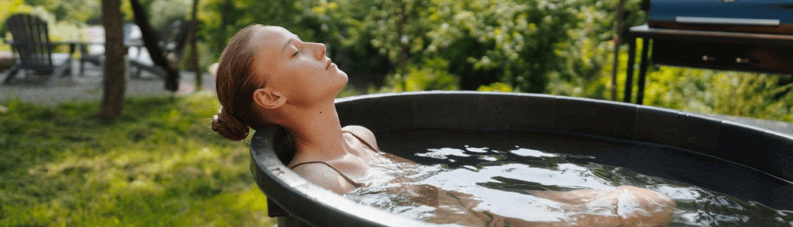 woman relaxing in cold plunge bath outside