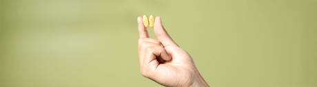 Hand holding two supplements.