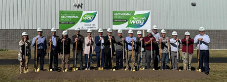 natures' way employees in front of building with shovels