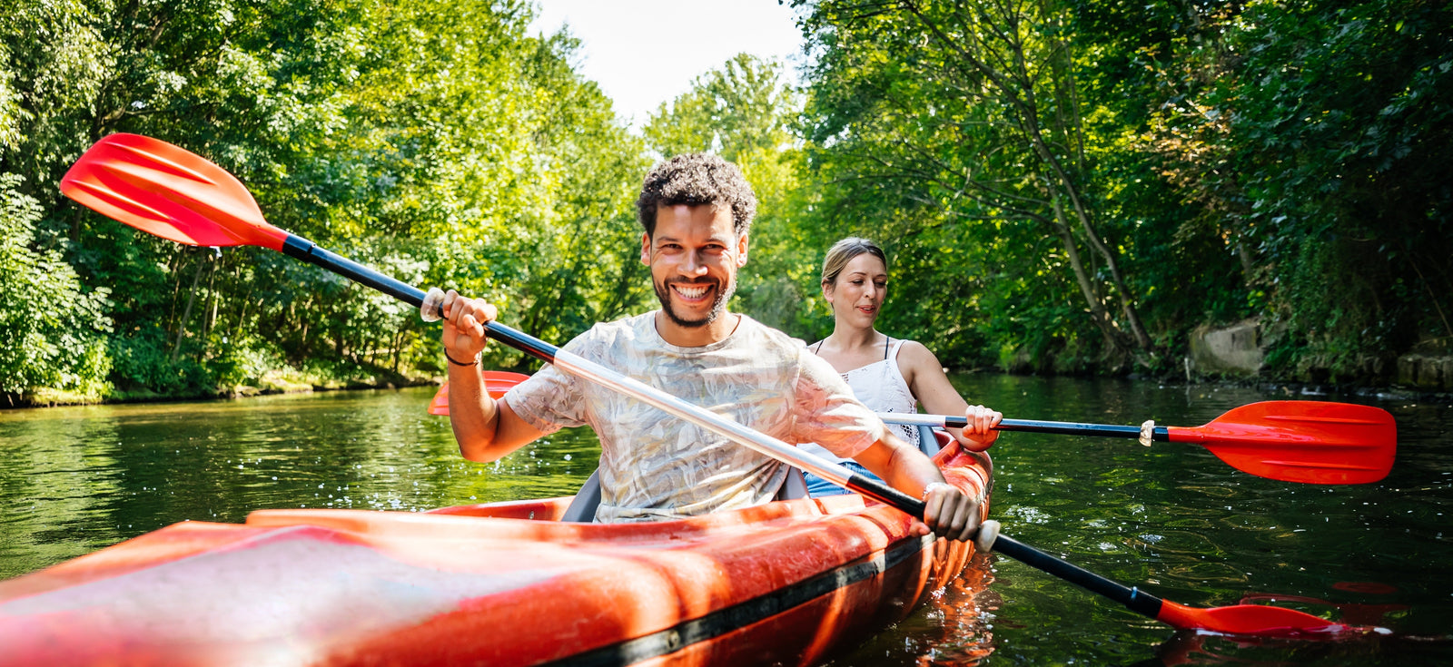 Couple kayaking down a river