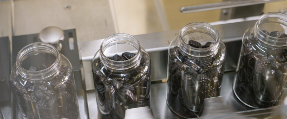 Clear bottles of gummies in the Nature's Way gummy factory.