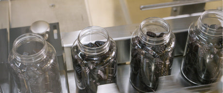 Clear bottles of gummies in the Nature's Way gummy factory.