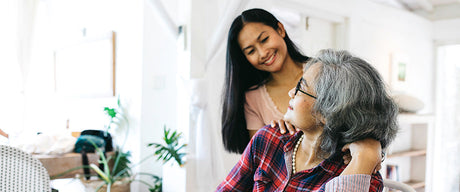 Two women smiling at each other.