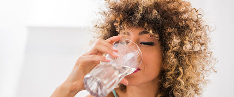 A woman drinking water.