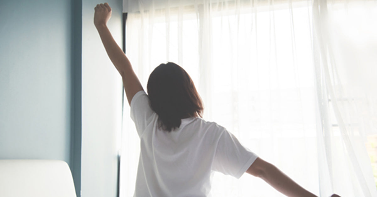 A woman stretching in the morning.