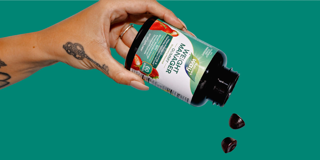 Hand holding Weight Manager Gummy bottle with gummies falling out.