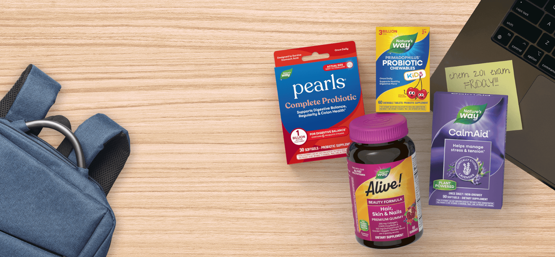 Supplement packages including 'pearls Complete Probiotic', and 'CalmAid' on a wooden surface.