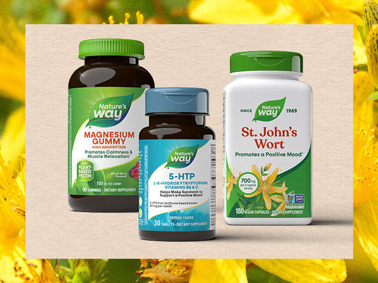 Three Nature's Way mood supplement bottles on a wooden block with a yellow flower background