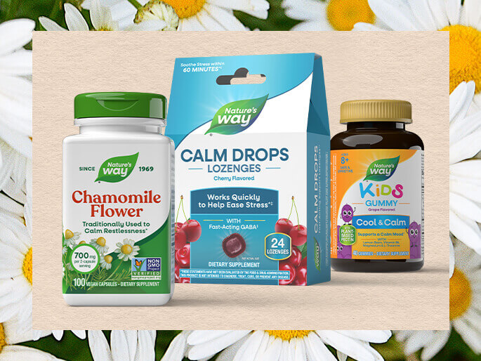Nature's Way health products including a bottle, box, and gummy on a wooden board with flowers in the background.