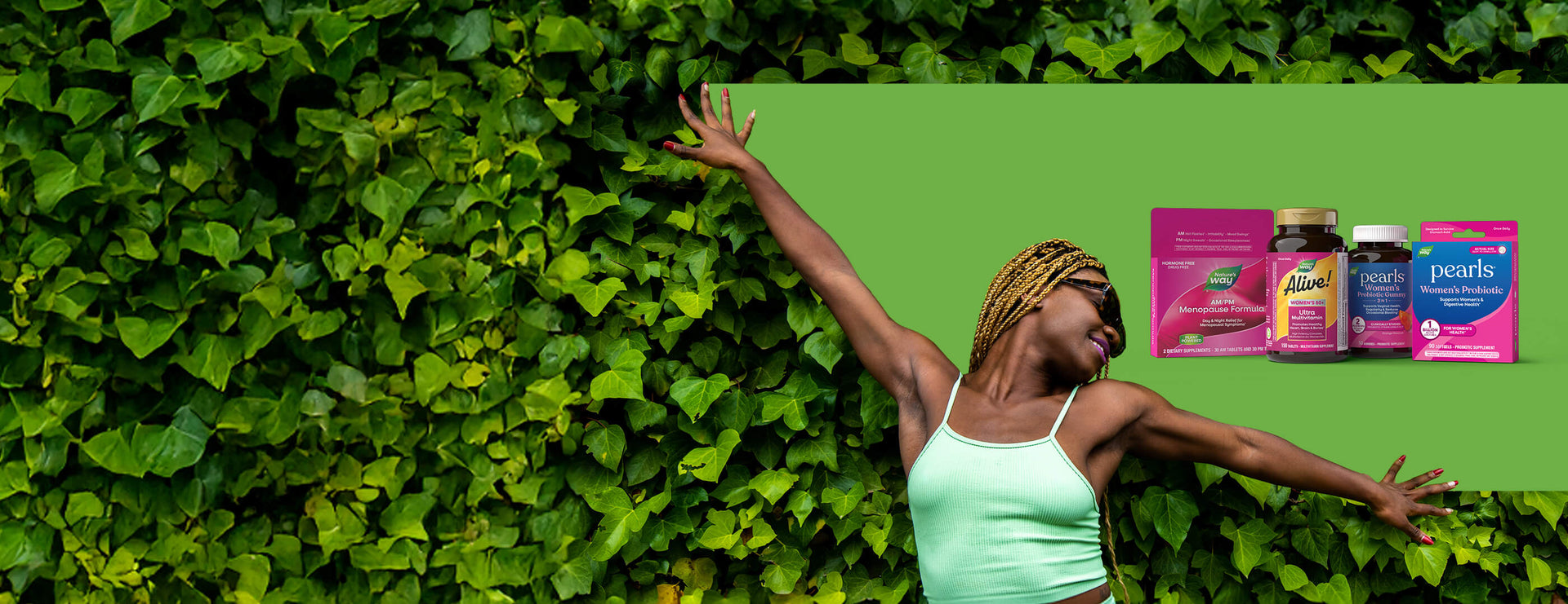 Woman with arms outstretched against a green leafy background with products displayed.