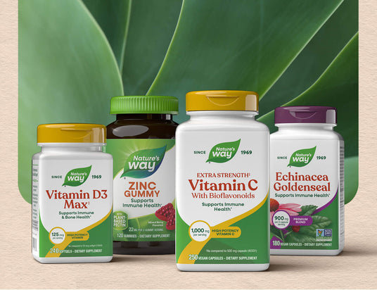 Assorted Nature's Way supplement bottles on a light beige background with green leaves.