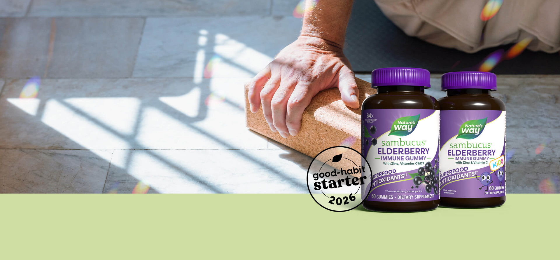 Two bottles of Nature's Way Elderberry on a table with a person climbing in the background.