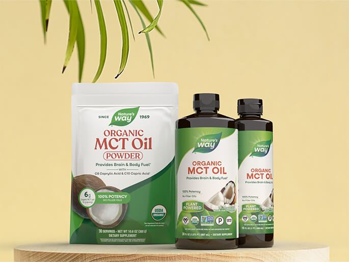 Nature's Way Organic MCT Oil products on a wooden surface with a yellow background