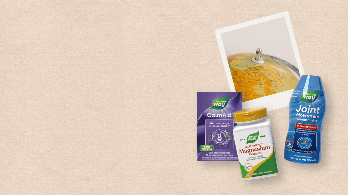 Three wellness products arranged on a light beige textured background: a purple CalmAid box, a Magnesium supplement bottle with a gold cap, and a blue Joint Movement bottle. A tilted polaroid-style photo of a globe is also shown above them.