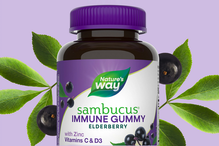 Nature's Way Sambucus immune gummy elderberry supplement bottle with purple cap and green leaves on a light purple background