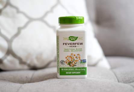 A bottle of Feverfew Herb sitting on a couch.