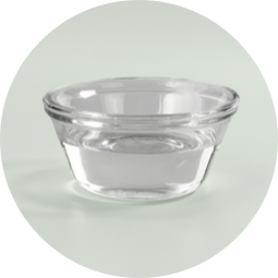 A small glass cup filled with oil.