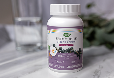 A bottle of Nature's Way Sambucus Kids 40 Chewable Tablets on a white countertop 