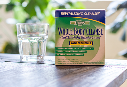 <{%DETAIL1_08450%}>Box of Nature's Way Whole Body Cleanse on brown table next to glass of water.